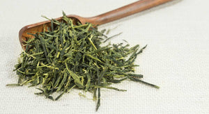 Japanese sencha green tea on the spoon