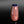 將圖片載入到圖庫檢視器中， A glossy ceramic bottle with a red and blue geometric floral pattern and a dark blue lid, set against a dark gradient background.
