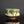 Load image into Gallery viewer, Ceramic bowl with green and brown glaze on a reflective surface with a dark background

