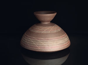 Ceramic vase with geometric patterns on a black background