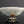 將圖片載入到圖庫檢視器中， A handmade ceramic bowl with a light gray and white glaze featuring a prominent crackle pattern, resting on a dark reflective surface against a dark gray background.
