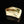 將圖片載入到圖庫檢視器中， A sculptural ceramic incense box (kōgō) by Ayukai Kōgetsu, modelled in a stylised Mount Fuji form. Its low, angular silhouette combines softly raised contours with flowing cream, olive-green and brown glazes.

The lid rises towards an irregular summit, with sloping sides suggesting the mountain’s distinctive outline. Uneven ridges and gently softened edges give the piece an organic character, interpreting the subject through expressive modelling rather than precise symmetry.
