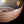 Load image into Gallery viewer, Close-up of a metallic bronze-colored bowl with gold circular accents on the interior, set against a solid black background.
