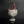 Load image into Gallery viewer, Vintage ceramic vase with a woven handle on a black background
