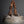 Load image into Gallery viewer, Vintage ceramic vase with a woven handle on a black background
