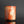 將圖片載入到圖庫檢視器中， A small cylindrical cup made of marbled orange, peach, and cream ceramic, standing on a reflective black surface against a black background.
