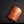 將圖片載入到圖庫檢視器中， A small cylindrical cup made of marbled orange, peach, and cream ceramic, standing on a reflective black surface against a black background.
