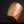 將圖片載入到圖庫檢視器中， A small cylindrical cup made of marbled orange, peach, and cream ceramic, standing on a reflective black surface against a black background.
