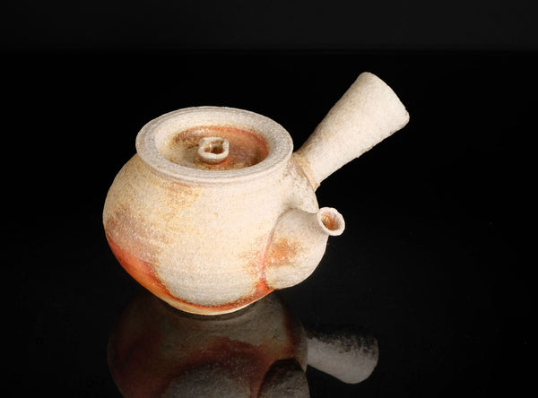 Ceramic a shigaraki guinomi  with a unique design on a black background