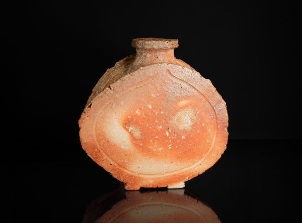 Ceramic sake flask with a glossy finish on a black background