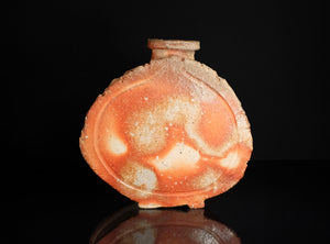 Ceramic sake flask with a glossy finish on a black background