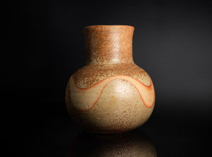 Ceramic vase with a speckled glaze and red accent on a black background