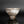 Load image into Gallery viewer, A handmade ceramic bowl with a textured, speckled glaze in shades of gray, brown, and white, standing on a dark reflective surface against a dark gray background.
