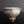 Load image into Gallery viewer, A handmade ceramic tea bowl with a textured, speckled glaze in off-white and brown tones, set against a dark gray background.
