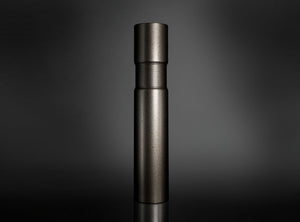 A dark metallic cylindrical flower vase standing upright on a reflective black surface against a dark gray gradient background.