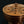 將圖片載入到圖庫檢視器中， Bronze-colored metal object with engraved patterns on a black background
