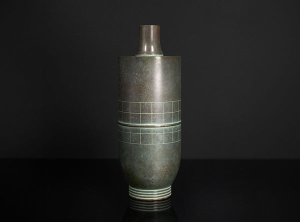 Tall vase with geometric design on a black background