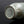 Load image into Gallery viewer, Close-up of a metallic cylindrical object with text on a dark background
