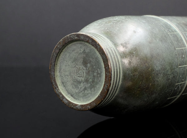 Close-up of a metallic cylindrical object with text on a dark background