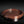 Load image into Gallery viewer, A round reddish-brown cast bronze tray with a segmented rim and engraved concentric circle details, displayed on a dark reflective surface.
