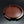 Load image into Gallery viewer, A round reddish-brown cast bronze tray with a segmented rim and engraved concentric circle details, displayed on a dark reflective surface.

