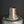 Load image into Gallery viewer, A close-up of an antique-style cylindrical bronze vase with a green patina and geometric grid engravings, set against a dark gray background.
