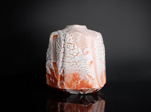 Decorative vase with a textured surface on a black background