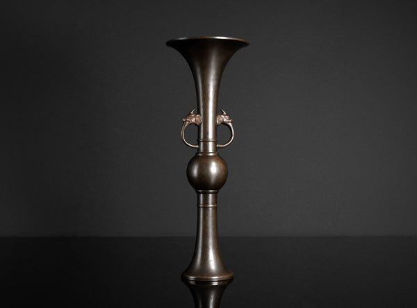 Bronze vase with a dark background