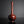 Load image into Gallery viewer, A glossy reddish-brown cast bronze vase with a bulbous base and a long, slender neck, standing on a dark reflective surface against a dark gray background.
