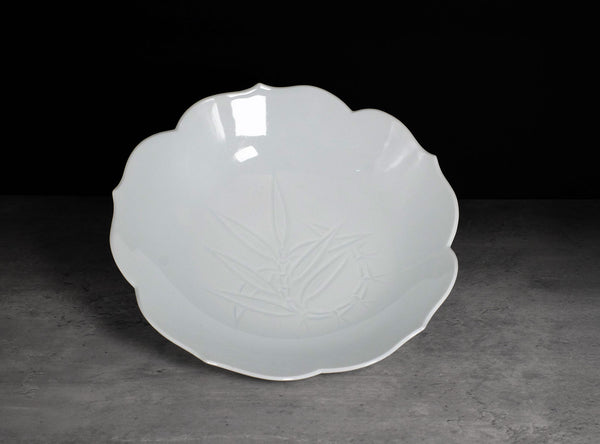 White ceramic plate with floral design on a dark background