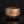 將圖片載入到圖庫檢視器中， Brown ceramic bowl on a black reflective surface with a dark background
