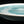 將圖片載入到圖庫檢視器中， Close-up of a ceramic plate with a light blue interior glaze on a black background

