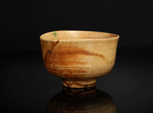 Ceramic bowl with brown glaze on a black background