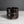 Load image into Gallery viewer, A dark brown glossy ceramic cup with a textured, wavy horizontal design, set against a neutral gray background.
