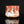 Load image into Gallery viewer, Ceramic mug with red and white glaze on a black background
