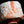 Load image into Gallery viewer, Close-up of a ceramic piece with white glaze and orange-brown speckles on a black background
