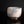 Load image into Gallery viewer, A handmade ceramic tea bowl with a textured, speckled glaze in shades of light blue-gray and warm cream, set against a solid black background with a soft reflection below.

