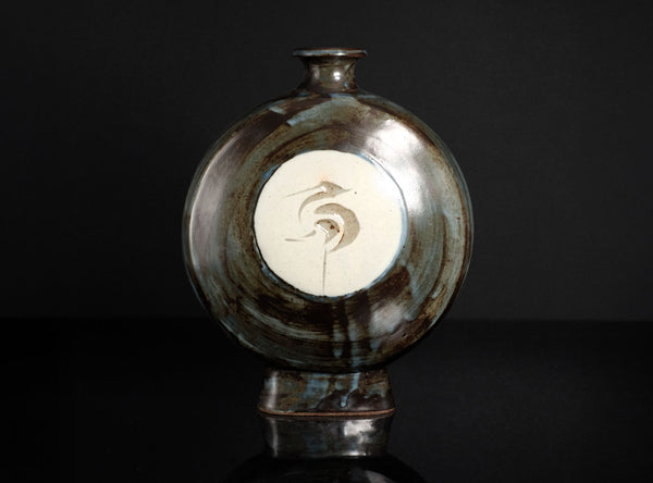 Ceramic vase with decorative design on a dark background