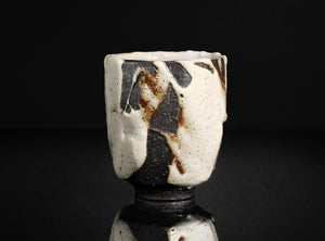 Ceramic cup with abstract design on a black background