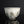 將圖片載入到圖庫檢視器中， A vintage ceramic bowl with a white glaze, featuring irregular gray and brown patches and speckles, set against a dark reflective background.
