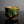 將圖片載入到圖庫檢視器中， A handmade ceramic tea bowl with a glossy, textured glaze in earthy brown and green tones, displayed on a reflective black surface against a dark gray background.
