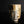 將圖片載入到圖庫檢視器中， A handmade ceramic cup with a textured, rustic finish featuring a mix of brown, beige, and white glazes, set against a dark black background.
