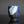 Load image into Gallery viewer, A handmade ceramic cup with a textured, faceted design, featuring a glossy blue and matte black glaze with a light blue and white cracked tile motif on the front, set against a dark background
