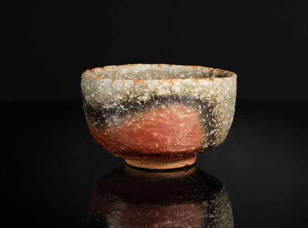 Vintage ceramic bowl with a textured surface on a black background