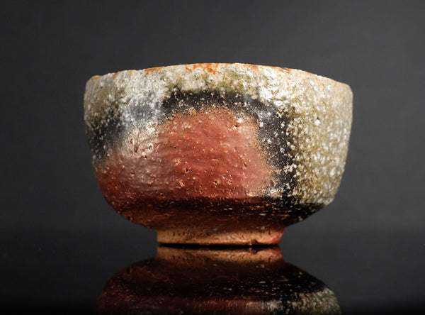 Ceramic bowl with a textured surface on a dark background