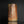 Load image into Gallery viewer, A handmade ceramic hexagonal vase with a rustic, textured surface in earthy terracotta and brown tones, standing on a reflective black surface against a dark background.
