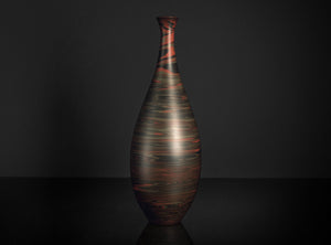 Decorative vase with a textured design on a dark background