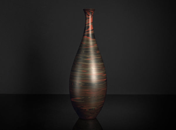 Decorative vase with a textured design on a dark background