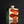 將圖片載入到圖庫檢視器中， A square ceramic bottle with a small neck and a stopper, featuring a white body with two large orange abstract shapes and a dark green side panel, set against a dark reflective background.
