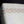 Load image into Gallery viewer, Close-up of a white ceramic vase with decorative lattice pattern on a black background
